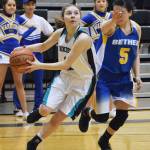 Nikiski&rsquo;s America Jeffreys (left) drives the baseline against Bethel&rsquo;s Dorothy Bukowski Saturday in the Class 3A girls state tournament fourth-place game at the UAA Wells Fargo Complex in Anchorage. (Photo by Joey Klecka/Peninsula Clarion)