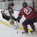 Kenai River skater Alex Klekotka (center) fights for the puck with Fairbanks&rsquo; Noah Wilson (right) Friday night at the MTA Events Center in Palmer. (Photo by Joey Klecka/Peninsula Clarion)