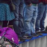 Spectators stand on a bench Friday night among a capacity crowd at the MTA Events Center in Palmer, watching a North American Hockey League contest between the Kenai River Brown Bears and the Fairbanks Ice Dogs. (Photo by Joey Klecka/Peninsula Clarion)