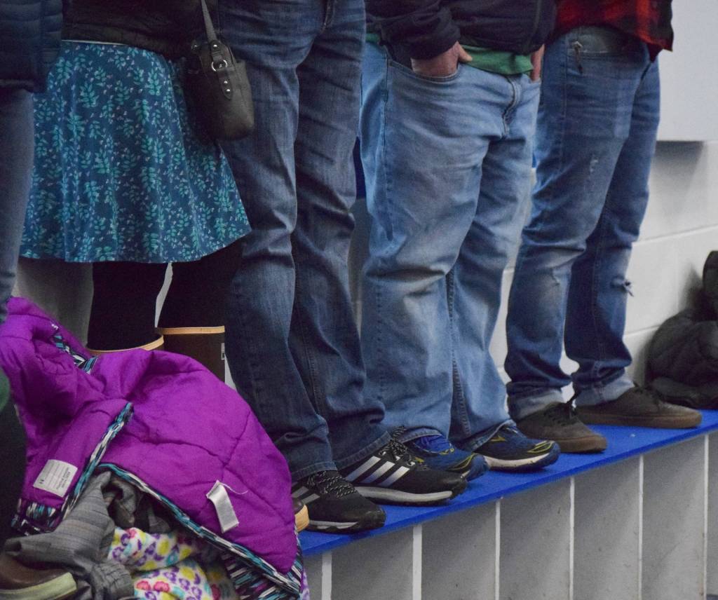 Spectators stand on a bench Friday night among a capacity crowd at the MTA Events Center in Palmer, watching a North American Hockey League contest between the Kenai River Brown Bears and the Fairbanks Ice Dogs. (Photo by Joey Klecka/Peninsula Clarion)