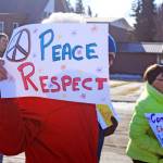 A woman holds a sign promoting respect during the Alaskans Choose Respect Awareness Event on March 28. Hosted by the LeeShore Center, the event aimed to bring awareness to the issue of domestic violence and sexual assault. (Photo by Erin Thompson/Peninsula Clarion)