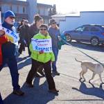 A dog leads the way during the Alaskans Choose Respect Awareness Event, hosted by the LeeShore Center, on Wednesday, March 28 in Kenai. The march aimed to draw attention to the issue of sexual assault and domestic violence. (Photo by Erin Thompson/Peninsula Clarion)