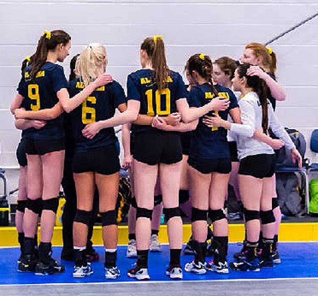 Soldotna&rsquo;s Shaylynn Zener (in white) huddles with the rest of her Alaska teammates at the 25th biannual Arctic Winter Games in Hay River, Canada. (Photo provided by Shaylynn Zener)