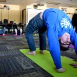 Soldotna High School student Jaron Swanson does bridge pose Friday while in a yoga class offered during the Focus on Learning period at the end of each school day. (Photo by Kat Sorensen/Peninsula Clarion)
