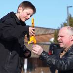 Asa Lorentzen (left) mounts a model rocket on its launch rod while instructor Scott Aleckson observes in the parking lot of the Soldotna Regional Sports Complex in Soldotna, Alaska on Saturday, May 31, 2018. Aleckson said he made and launched his first plastic, balsa wood, and cardboard rocket as a 4th grade student at Soldotna Elementary School. Since then he&rsquo;s built a custom launch system, he said, &ldquo;with recycled electronics and a lot of soldering time.&rdquo; Aleckson taught Saturday&rsquo;s rocketry class through the Soldotna Community Schools program, and would like to continue spreading the hobby. &ldquo;If I could get a model rocket club going, that&rsquo;d be great,&rdquo; he said. &ldquo;Stuff like this is much more fun in a group.&rdquo; (Photo by Ben Boettger/Peninsula Clarion)