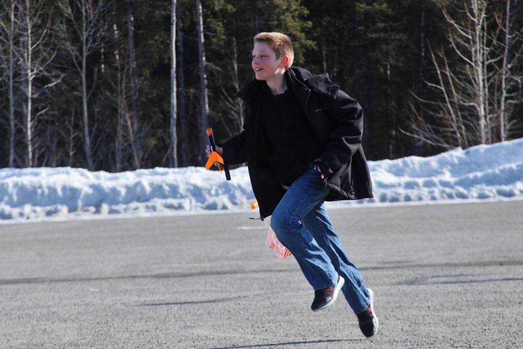 After catching a model rocket as it parachuted to Earth, Asa Lorentzen returns to the launch site during Scott Aleckson&rsquo;s model rocketry class in the parking lot of the Soldotna Regional Sports Complex in Soldotna, Alaska on Saturday, May 31, 2018. Aleckson said he made and launched his first plastic, balsa wood, and cardboard rocket as a 4th grade student at Soldotna Elementary School. Since then he&rsquo;s built a custom launch system, he said, &ldquo;with recycled electronics and a lot of soldering time.&rdquo; Aleckson taught Saturday&rsquo;s rocketry class through the Soldotna Community Schools program, and would like to continue spreading the hobby. &ldquo;If I could get a model rocket club going, that&rsquo;d be great,&rdquo; he said. &ldquo;Stuff like this is much more fun in a group.&rdquo;