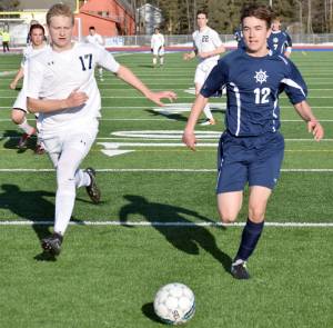 Soldotna&rsquo; Gavin Goggia and Homer&rsquo;s Daniel Reutov battle for the ball April 11, 2017, at Soldotna High School. (Photo by Jeff Helminiak/Peninsula Clarion)