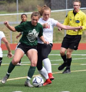 Kenai Central&rsquo;s Liz Hanson (right) battles for possession with a Colony player in a consolation semifinal May 26, 2017, at the girls state soccer tournament at Eagle River High School. (Photo by Joey Klecka/Peninsula Clarion)