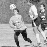 Nikiski&rsquo;s Deidra Lamping heads the ball wide of the goal as Redington goalie Grace Rushing and defender Courtney Crocket look on May 12, 2017, at Nikiski High School. (Photo by Jeff Helminiak/Peninsula Clarion)