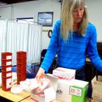 Homer Needle Exchange volunteer Sharon Whytal demonstrates a variety of items offered to IV drug users through the exchange program in Homer last month. (Photo by Erin Thompson/Peninsula Clarion)