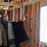 Contractor Ward Adams (left) and Nikiski resident Kimbra Mensch chat inside the shell of her home on Friday, March 9, 2018 in Nikiski, Alaska. Mensch, who moved to Nikiski from Wasilla, engaged a contractor to build her a home on Cabin Lake but is now having to tear it down because of mistakes in the construction. (Photo by Elizabeth Earl/Peninsula Clarion)