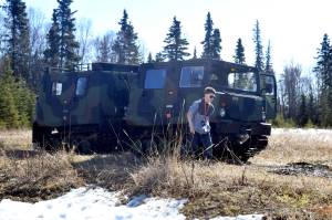 A guest at Saturday&rsquo;s National Guard Demo Day at the Kenai Armory in Kenai walks from a small until support vehicle, which is used by the Guard to traverse all different types of terrain. (Photo by Kat Sorensen/Peninsula Clarion)
