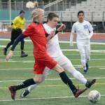 Houston&rsquo;s Jokob Hodge and Soldotna&rsquo;s Eli Sheridan tangle for the ball Wednesday, April 18, 2018, at Soldotna High School. (Photo by Jeff Helminiak/Peninsula Clarion)