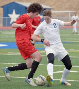 Houston&rsquo;s Nico Wilkenson and Soldotna&rsquo;s Cody Quelland battle for the ball Wednesday, April 18, 2018, at Soldotna High School. (Photo by Jeff Helminiak/Peninsula Clarion)