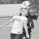 Kenai Central&rsquo;s Brenna Eubank controls the ball in front of Nikiski&rsquo;s Tika Zimmerman on Monday at Kenai Central High School. (Photo by Jeff Helminiak/Peninsula Clarion)