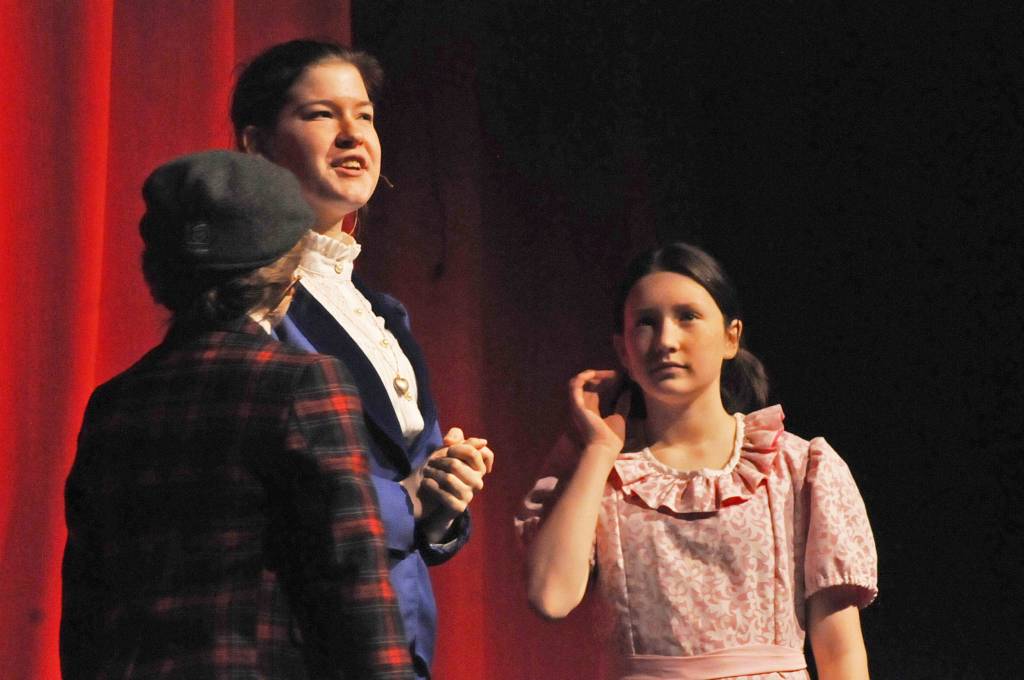 Mary Poppins (played by Emilee Tiner) speaks to Jane (Leora McCaughey) and Michael Banks (Brynne Tedford) during a dress rehearsal for Nikiski Middle-High School&rsquo;s production of &ldquo;Mary Poppins&rdquo; on Monday, April 23, 2018 in Nikiski, Alaska. The play premiers Friday at 7 p.m. at the high school. Tickets are $15. (Photo by Elizabeth Earl/Peninsula Clarion)