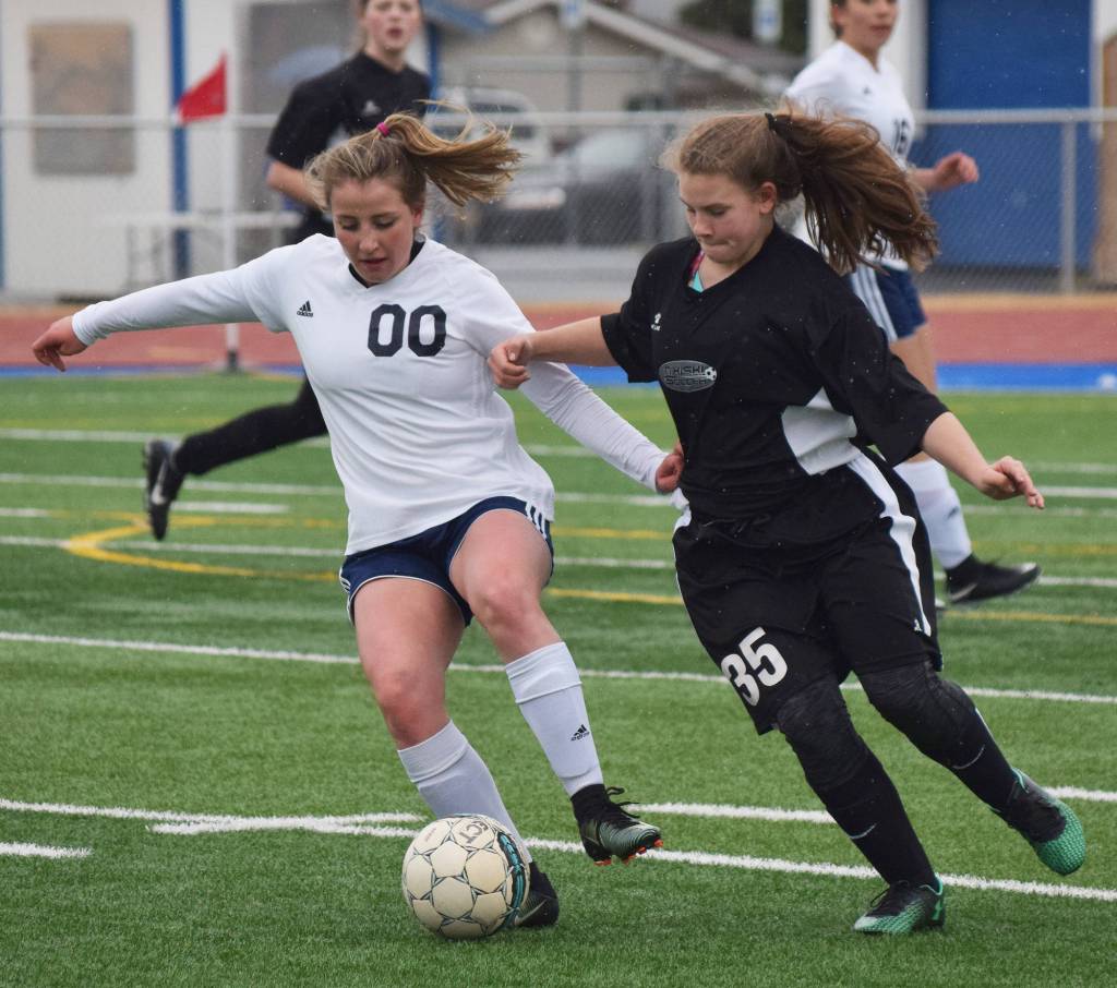 Soldotna&rsquo;s Ryann Cannava (00) looks for an opening against Nikiski defender Madelin Weeks Tuesday evening at Soldotna High School. (Photo by Joey Klecka/Peninsula Clarion)