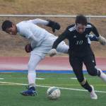 Soldotna&rsquo;s Alex Montague (left) and Nikiski&rsquo;s Michael Mysing battle for possession Tuesday evening at Soldotna High School. (Photo by Joey Klecka/Peninsula Clarion)
