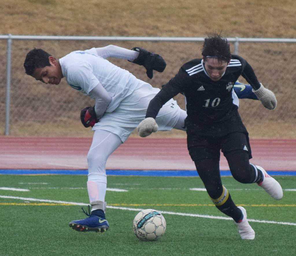 Soldotna&rsquo;s Alex Montague (left) and Nikiski&rsquo;s Michael Mysing battle for possession Tuesday evening at Soldotna High School. (Photo by Joey Klecka/Peninsula Clarion)