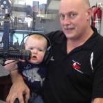 Former Soldotna High School coach Dan Gensel poses at the KSRM Radio studios with grandson Brendan Frey. (Photo provided by Dan Gensel)
