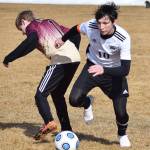 Nikiski&rsquo;s Michael Mysing (10) wins the fight for the ball over Grace Christian&rsquo;s Seth Kneigge Friday at Nikiski High School. (Photo by Joey Klecka/Peninsula Clarion)