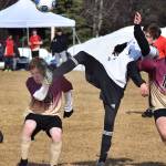 Paul Kopp of Grace Christian (left) dodges the leg of Nikiski&rsquo;s Mason Payne Friday at Nikiski High School. (Photo by Joey Klecka/Peninsula Clarion)