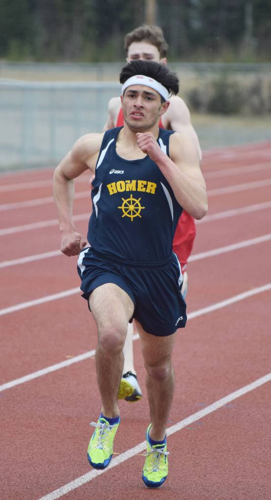 Homer junior Luciano Fasulo holds off ACS freshman Tristian Merchant in the boys 1,600 meters Saturday at the Kenai Invitational at Ed Hollier Field. (Photo by Joey Klecka/Peninsula Clarion)