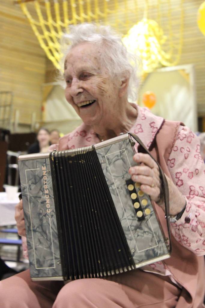 Wilma Gregory celebrates her 100th birthday Saturday by serenading family and friends to &ldquo;Mockingbird Hill&rdquo; played on her accordion. The celebration was held at McNeil Canyon School. (Photo by McKibben Jackinsky)