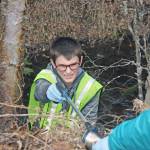 Girl Scouts Caitlyn Crapps, left, and Kadie Newkirk, discard a plastic glove during Kenai National Wildlife Refuge&rsquo;s Green Up, Clean Up event on Wednesday, May 2, 2018. (Photo by Erin Thompson/Peninsula Clarion)