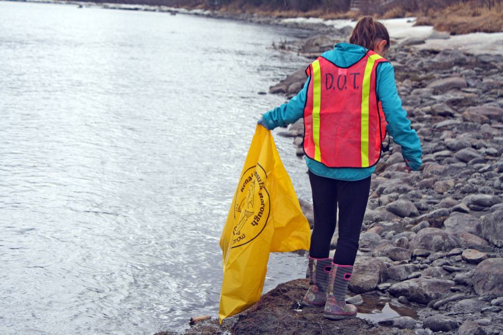 Ryan Crapps hands up trash from a stream near Keystone Drive in Soldotna during the Kenai National Wildlife Refuge&rsquo;s Green Up, Clean Up event on Wednesday, May 2, 2018. Approximately 45 people, including three Girl Scout troops, spent the afternoon cleaning up roadsides along the refuge as part of a week-long effort by refuge staff to rid roadways of trash accumulated during the winter months. (Photo by Erin Thompson/Peninsula Clarion)