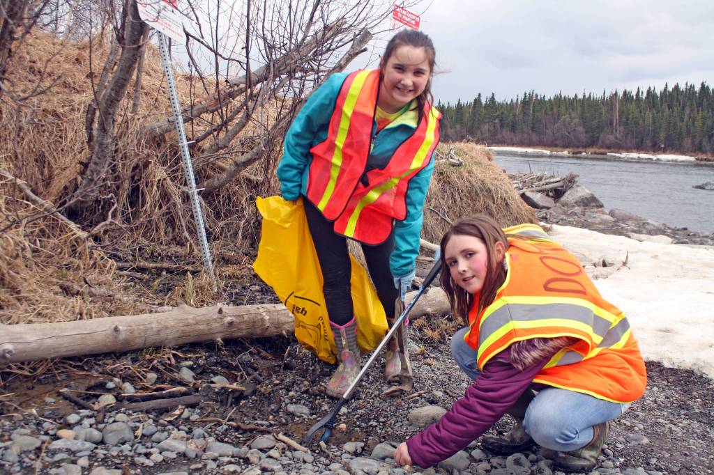 Girl Scout Caitlyn Crapps searches for trash along the Kenai River in Soldotna during the May 2 Green Up, Clean Up event hosted by the Kenai National Wildlife Refuge. (Photo by Erin Thompson/Peninsula Clarion)