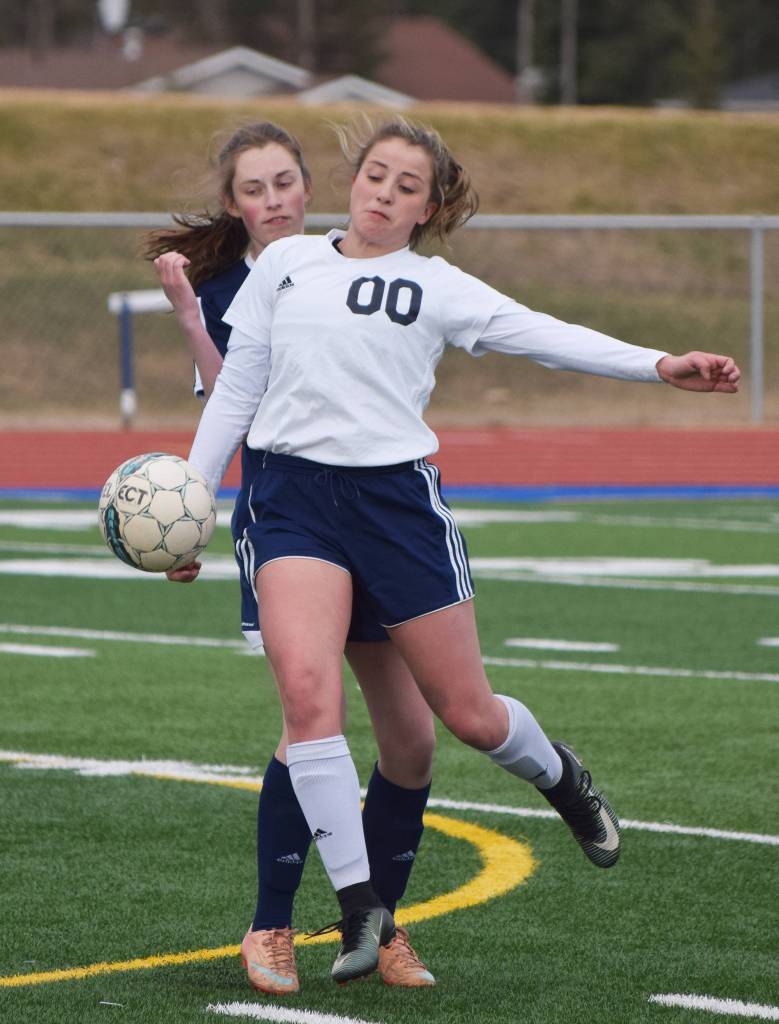 Soldotna&rsquo;s Ryann Cannava (00) blocks the ball from Homer&rsquo;s Andie Sonnen Thursday afternoon in a Peninsula Conference contest at Soldotna High School. (Photo by Joey Klecka/Peninsula Clarion)