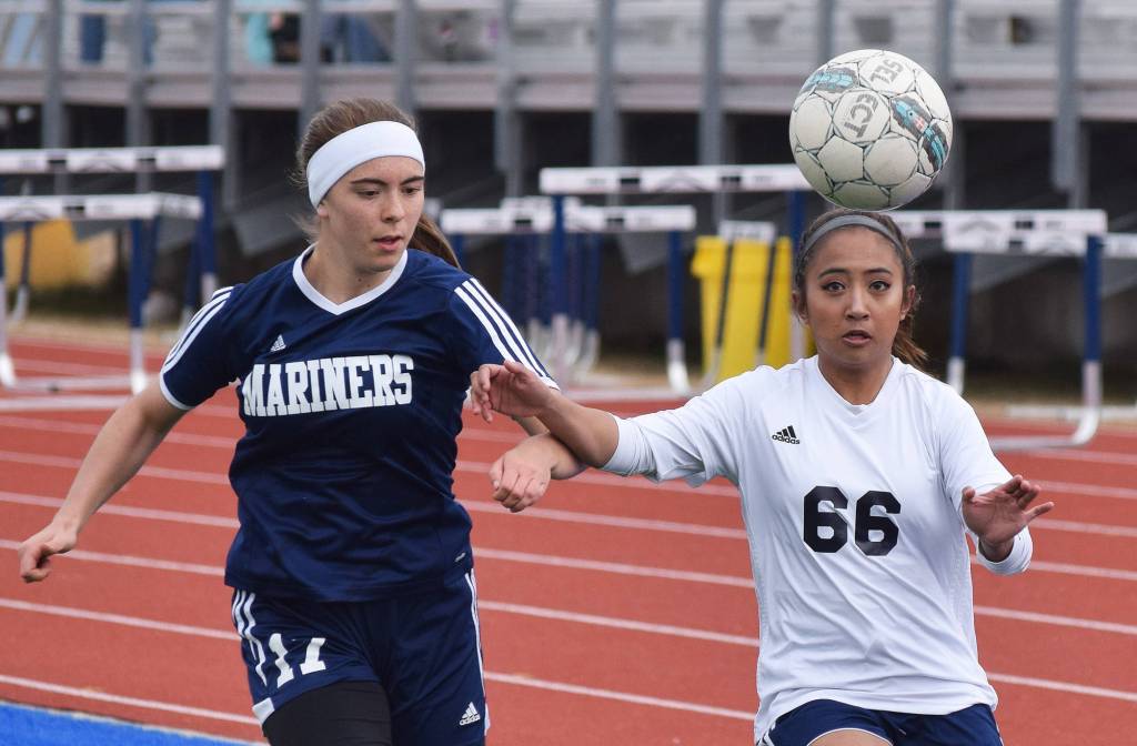 Homer&rsquo;s Summer McGuire and Soldotna&rsquo;s Paulyne Catacutan (66) battle for the ball Thursday afternoon in a Peninsula Conference contest at Soldotna High School. (Photo by Joey Klecka/Peninsula Clarion)