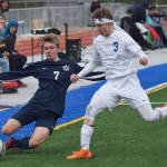 Homer&rsquo;s Simon Dye attempts to trap the ball at the sideline with Soldotna&rsquo;s Luke Trammell Thursday afternoon in a Peninsula Conference contest at Soldotna High School. (Photo by Joey Klecka/Peninsula Clarion)