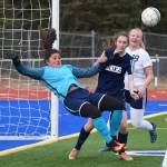 Soldotna goalkeeper Maddie Kindred falls after colliding with Homer&rsquo;s Andie Sonnen Thursday afternoon in a Peninsula Conference contest at Soldotna High School. (Photo by Joey Klecka/Peninsula Clarion)
