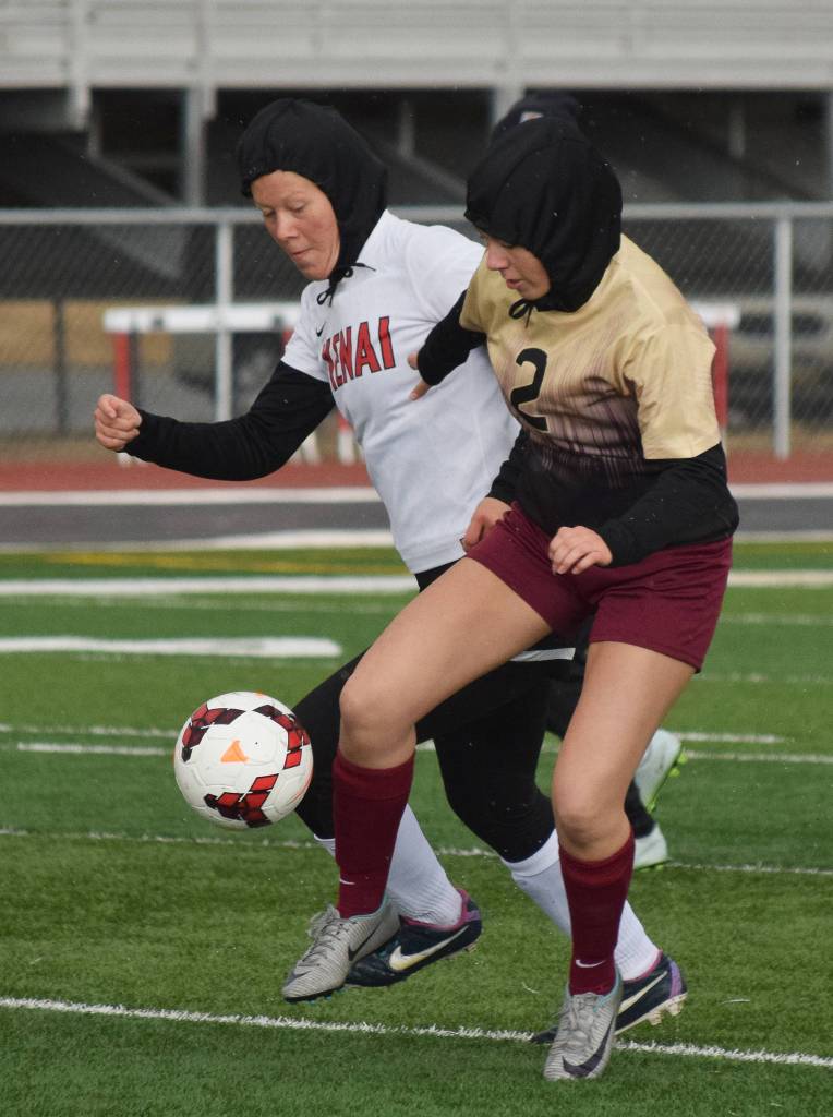 Kenai&rsquo;s Anya Danielson (left) battles for the ball with Grace Christian&rsquo;s Eveny Miller early in Saturday&rsquo;s girls game at Kenai Central High School. (Photo by Joey Klecka/Peninsula Clarion)