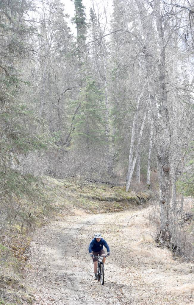 Andy Kircher cruises down a hill Sunday, May 6, 2018, during May Cross at Tsalteshi Trails. (Photo by Jeff Helminiak/Peninsula Clarion)