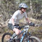 Jen Showalter cruises down the trails Sunday, May 6, 2018, at May Cross at Tsalteshi Trails. (Photo by Jeff Helminiak/Peninsula Clarion)