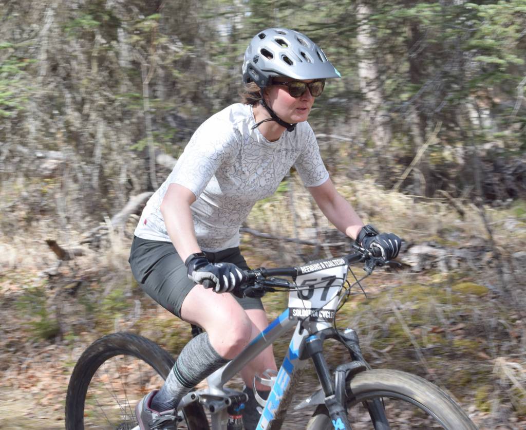 Jen Showalter cruises down the trails Sunday, May 6, 2018, at May Cross at Tsalteshi Trails. (Photo by Jeff Helminiak/Peninsula Clarion)