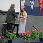 Chanelle Frances Usvat accepts her diploma from Cook Inlet Academy in Soldotna, Alaska, on Sunday, May 6. Usvat, who graduated summa cum laude, plans to attend the University of Alaska Anchorage in the fall and hopes to become a psychiatric mental health nurse practitioner. (Photo by Erin Thompson/Peninsula Clarion)