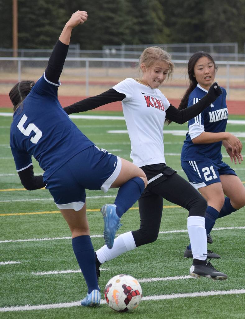 Homer&rsquo;s Kimberly Lynn (5) attempts to stop a run from Kenai Central&rsquo;s Karley Harden Tuesday evening at Ed Hollier Field in Kenai. (Photo by Joey Klecka/Peninsula Clarion)