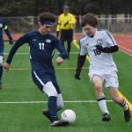 Homer&rsquo;s Charlie Menke (11) and Kenai Central&rsquo;s Damien Redder tussle for the ball Tuesday evening at Ed Hollier Field in Kenai. (Photo by Joey Klecka/Peninsula Clarion)