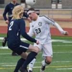 Kenai&rsquo;s Zack Tuttle (23) and Homer&rsquo;s Charles Rohr battle for a header Tuesday evening at Ed Hollier Field in Kenai. (Photo by Joey Klecka/Peninsula Clarion)