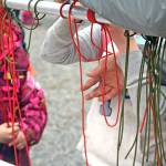 Students participate in a knot-tying demonstration during the 18th Annual Kenai Peninsula Salmon Celebration at Johnson Lake State Recreation Site in Kasilof. The fish-release event featured hands-on activity and demonstration booths focused around wildlife education and safety. (Photo by Erin Thompson/Peninsula Clarion)