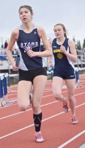 Soldotna&rsquo;s Kellie Arthur tries to hold off Homer&rsquo;s Autumn Daigle in the final leg of the 3,200-meter relay Saturday, May 12, 2018, at Soldotna High School. Daigle would pass Arthur for the victory. (Photo by Jeff Helminiak/Peninsula Clarion)