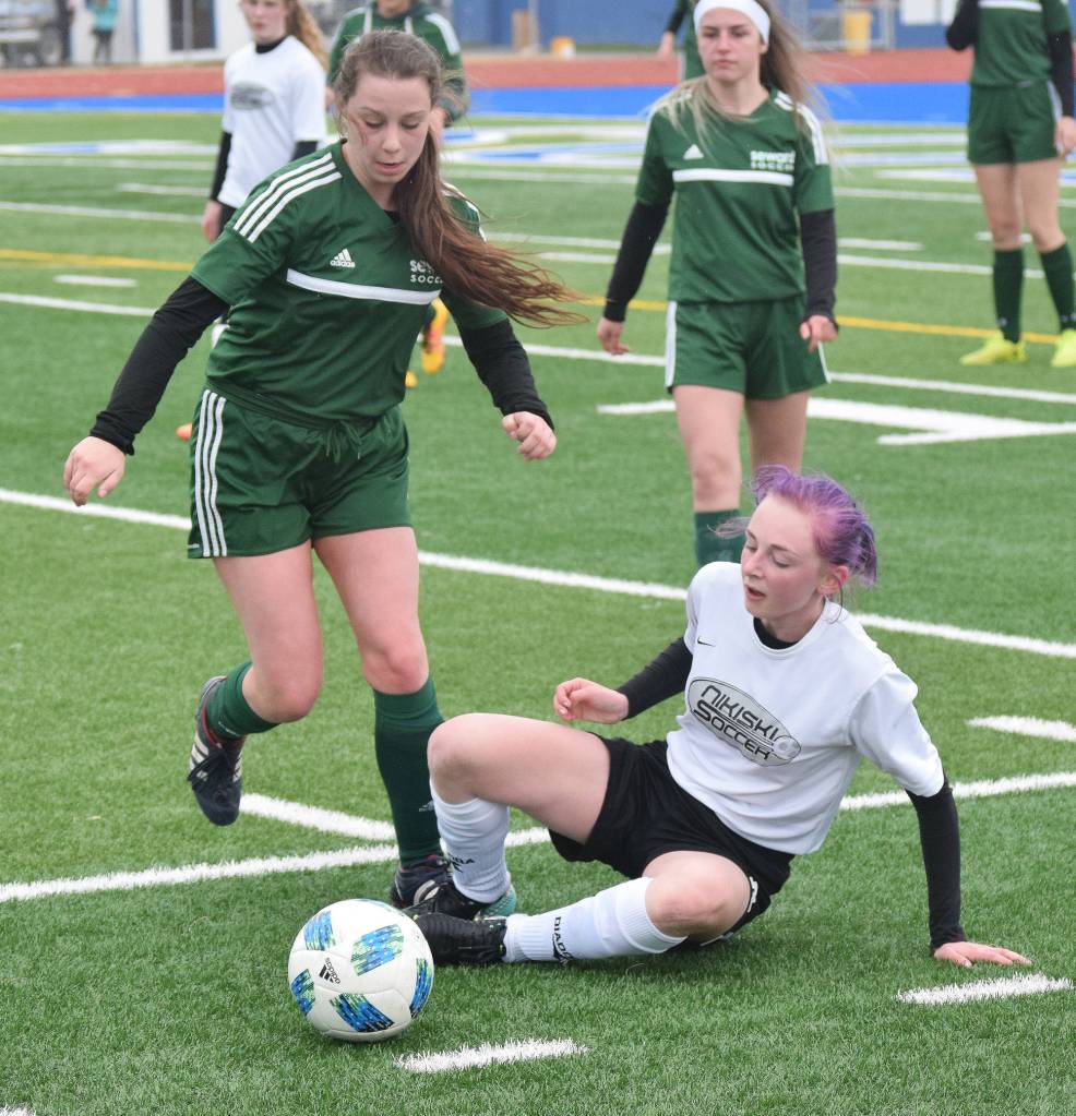 Nikiski&rsquo;s Cailin Yeager (right) takes a fall after battling with Seward&rsquo;s Rose Terry for the ball Thursday at the Peninsula Conference tournament at Soldotna High School. (Photo by Joey Klecka/Peninsula Clarion)