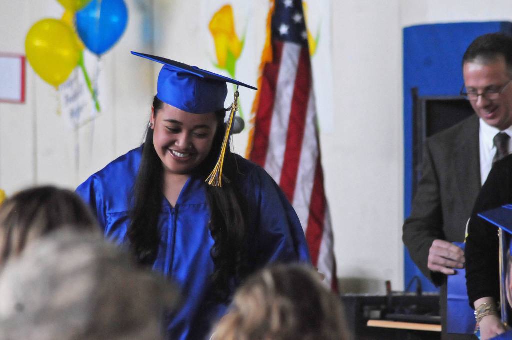 Kenai Alternative High School graduate Destinee Jennings returns to her seat after receiving an award at the high school&rsquo;s graduation ceremony on Tuesday, May 22, 2018 in Kenai, Alaska. Kenai Alternative High School provides more flexible edcuation for students who struggled in traditional high school environments, scheduling classes around jobs, children and life circumstances to help students achieve their high school diplomas. (Photo by Elizabeth Earl/Peninsula Clarion)