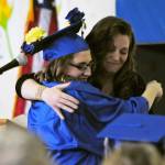 Kenai Alternative High School graduate Larissa Pittman hugs school secretary Jacquelynn Tomrdle at the high school&rsquo;s graduation ceremony on Tuesday, May 22, 2018 in Kenai, Alaska. Kenai Alternative High School provides more flexible edcuation for students who struggled in traditional high school environments, scheduling classes around jobs, children and life circumstances to help students achieve their high school diplomas. (Photo by Elizabeth Earl/Peninsula Clarion)