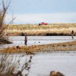 Anglers cross the meandering streams near the mouth of the Anchor River on Saturday, May 19, 2018 in Anchor Point, Alaska. The Anchor River opening May 19 was the first chance for freshwater anglers on the Kenai Peninsula to catch king salmon. Saturday proved a slow morning for fishing &mdash; Umatum said he waited about 5 hours to catch his king &mdash; though it&rsquo;s still early in the season. The Alaska Department of Fish and Game&rsquo;s weir on the Anchor River has counted precisely zero kings so far this year, as of May 17, though the weir is positioned several miles upriver from the mouth. (Photo by Elizabeth Earl/Peninsula Clarion)