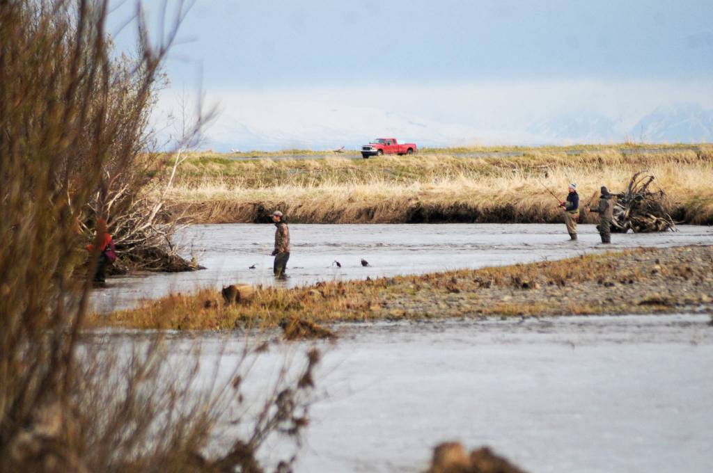 Anglers cross the meandering streams near the mouth of the Anchor River on Saturday, May 19, 2018 in Anchor Point, Alaska. The Anchor River opening May 19 was the first chance for freshwater anglers on the Kenai Peninsula to catch king salmon. Saturday proved a slow morning for fishing &mdash; Umatum said he waited about 5 hours to catch his king &mdash; though it&rsquo;s still early in the season. The Alaska Department of Fish and Game&rsquo;s weir on the Anchor River has counted precisely zero kings so far this year, as of May 17, though the weir is positioned several miles upriver from the mouth. (Photo by Elizabeth Earl/Peninsula Clarion)